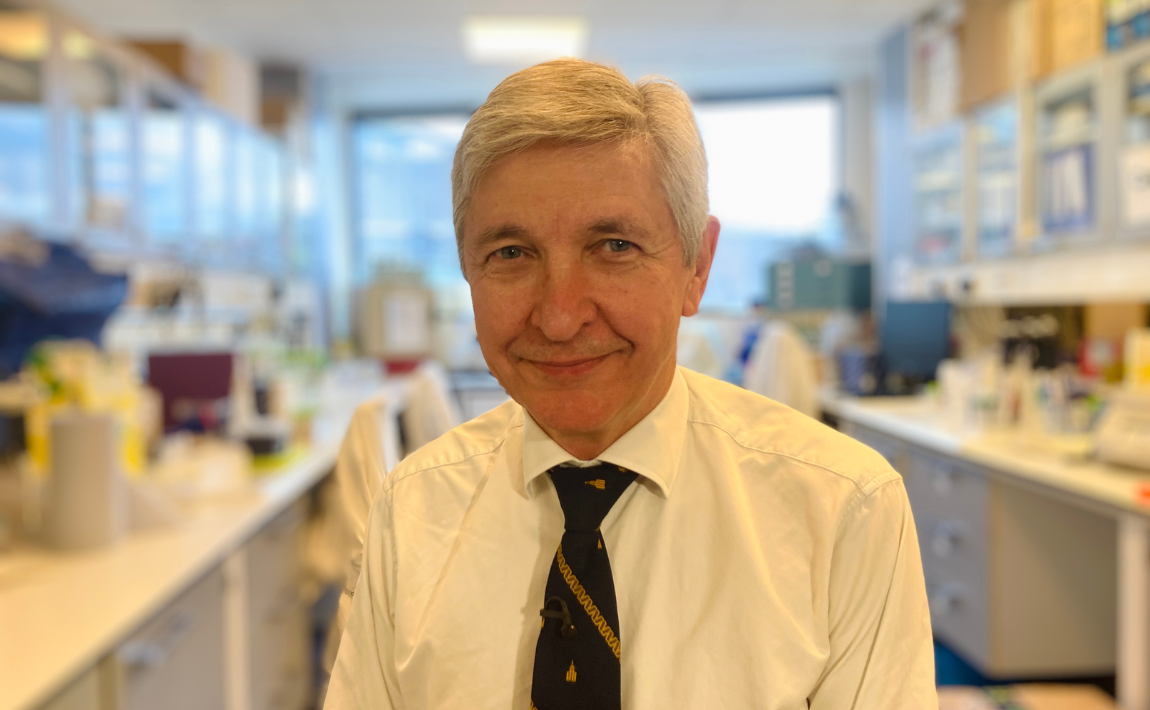 Headshot of Sir John Burn in a laboratory 