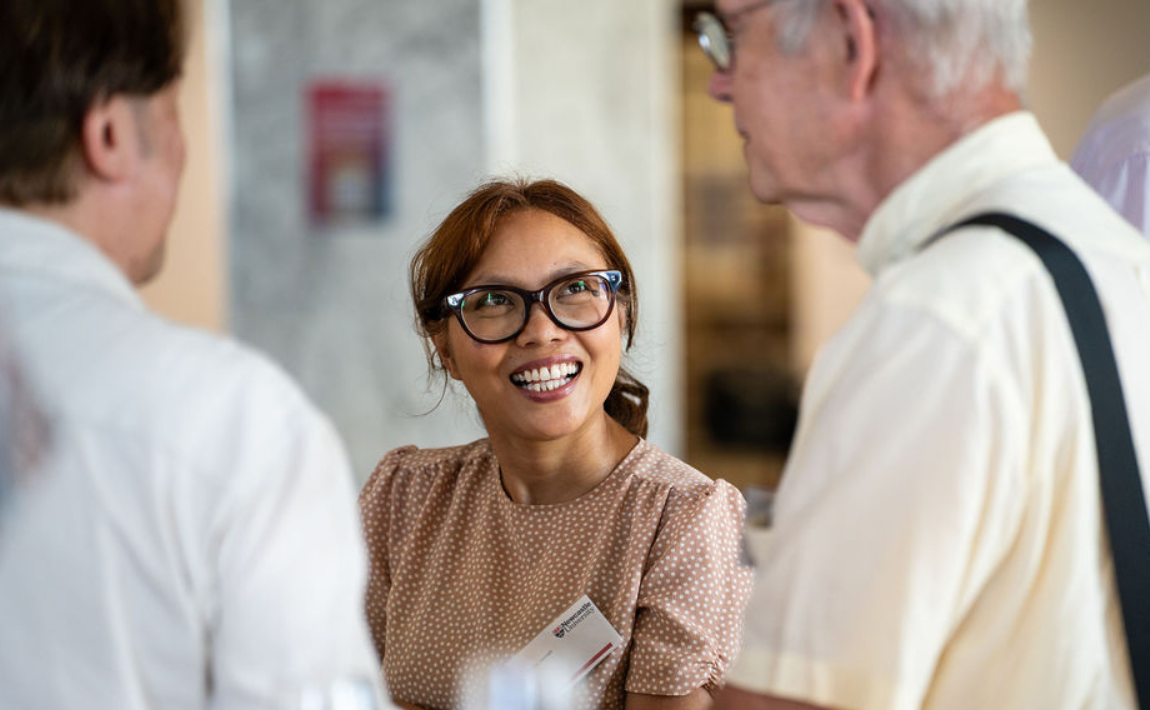 Alumna smiling at a networking event