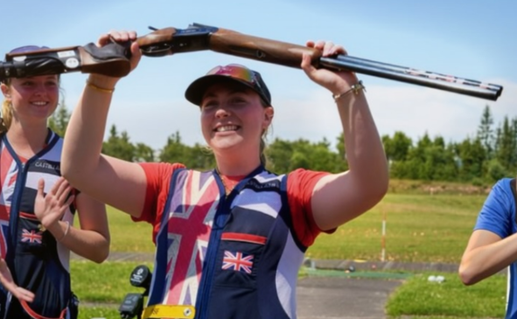 Bethany in her Team GB sport kit celebrating by holding her gun above her head