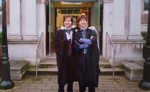 Daniel and his twin brother stood outside the Students