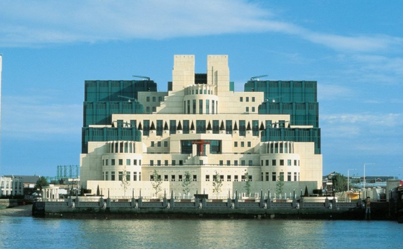 Vauxhall Cross MI6 building lit up at dusk
