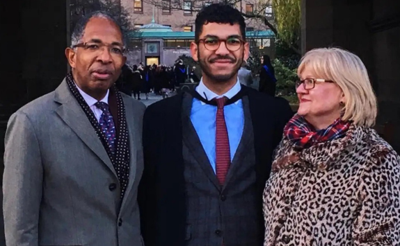 Will in front of the Percy Building with his parents on graduation day