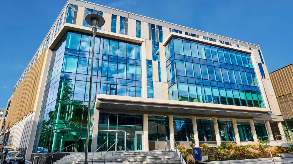 Exterior view of the Dame Margaret Barbour building, featuring a multi-storey glass façade, landscaped entrance and contemporary architectural design.