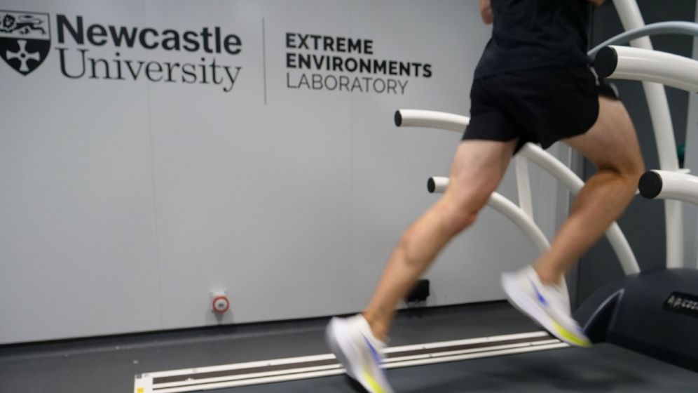 Participant running on a treadmill inside Newcastle University's Extreme Environments Laboratory, a specialist facility used to assess human performance under controlled temperature and altitude conditions.