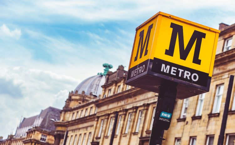 A yellow cube on a pole with the Tyne & Wear Metro logo in Grey Street