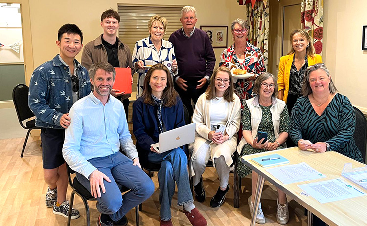 Group shot of June 2025 NICRE Techy tea Party attendees sat in Stannington Village Hall