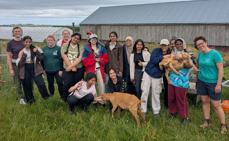 Members of the NUBS Women’s Network pose together with goats during a visit to a farm in Northumberland.
