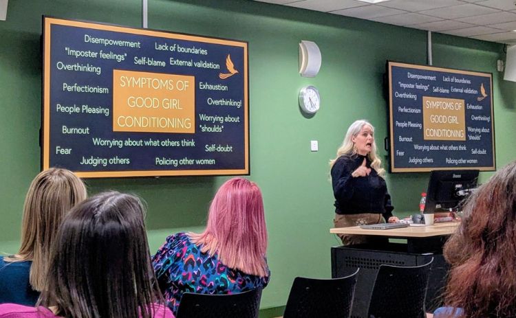 Women’s Network members attend a Good Girl Deprogramming workshop, with a speaker presenting on the symptoms of ‘good girl conditioning’.