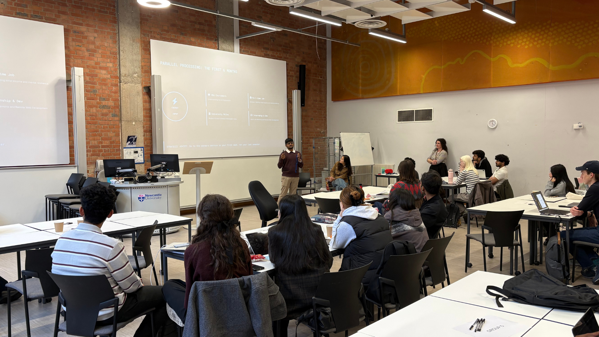 Photo of alumnus giving presentation to students 