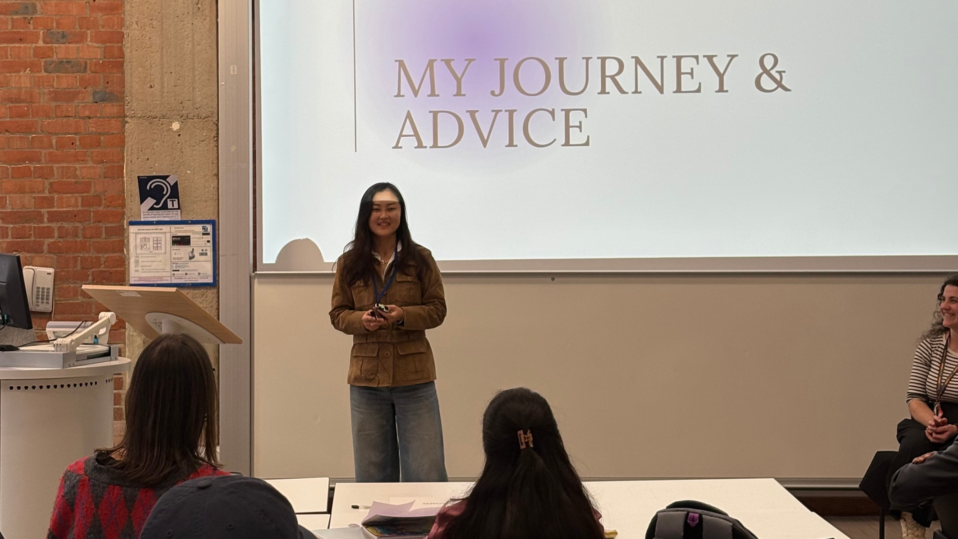 Alumni giving a presentation about her UK workplace experience 