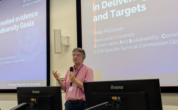 Philip McGowan of Newcastle University delivers a presentation on achieving global biodiversity goals through collaboration at the Science for Engagement Conference 2025