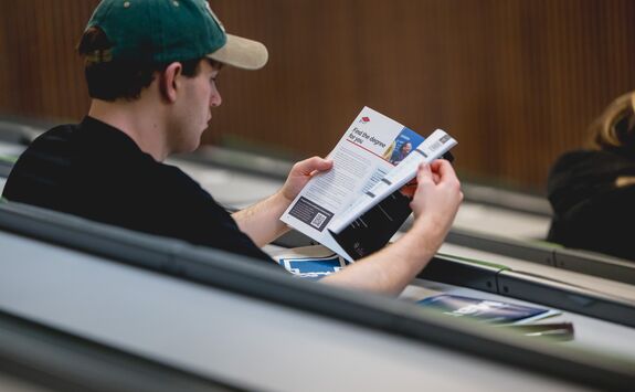 A young person browsing our prospectus of courses.