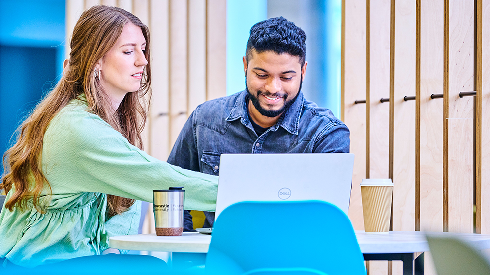 2 students working together on a laptop
