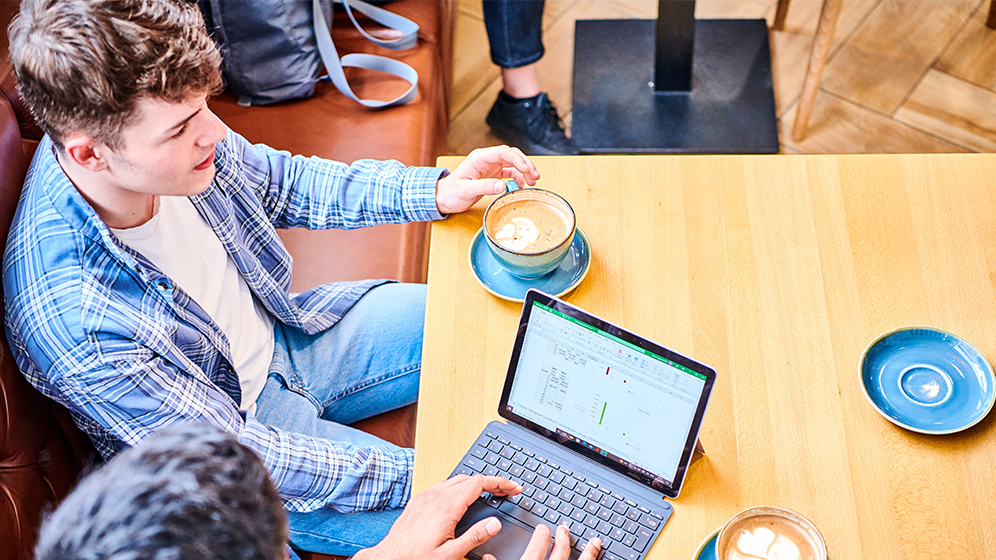 Two students working together in a cafe