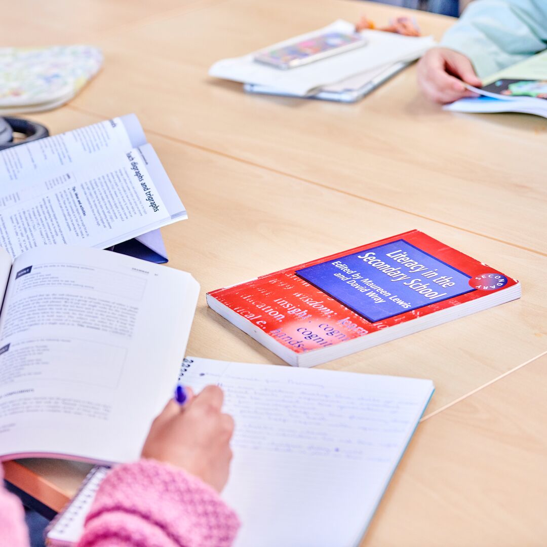 A student reading through textbooks