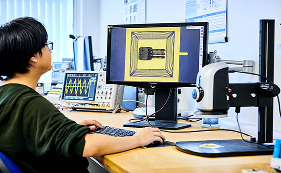 A student working at a desktop computer.