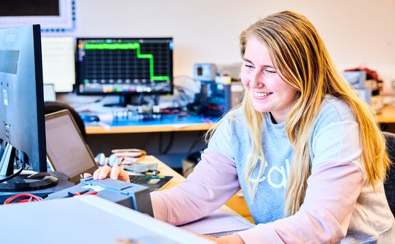 A student using a piece of electrical equipment.