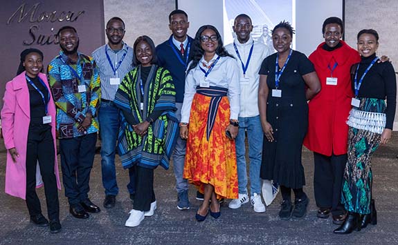 Students with international scholarships pose inside at St James