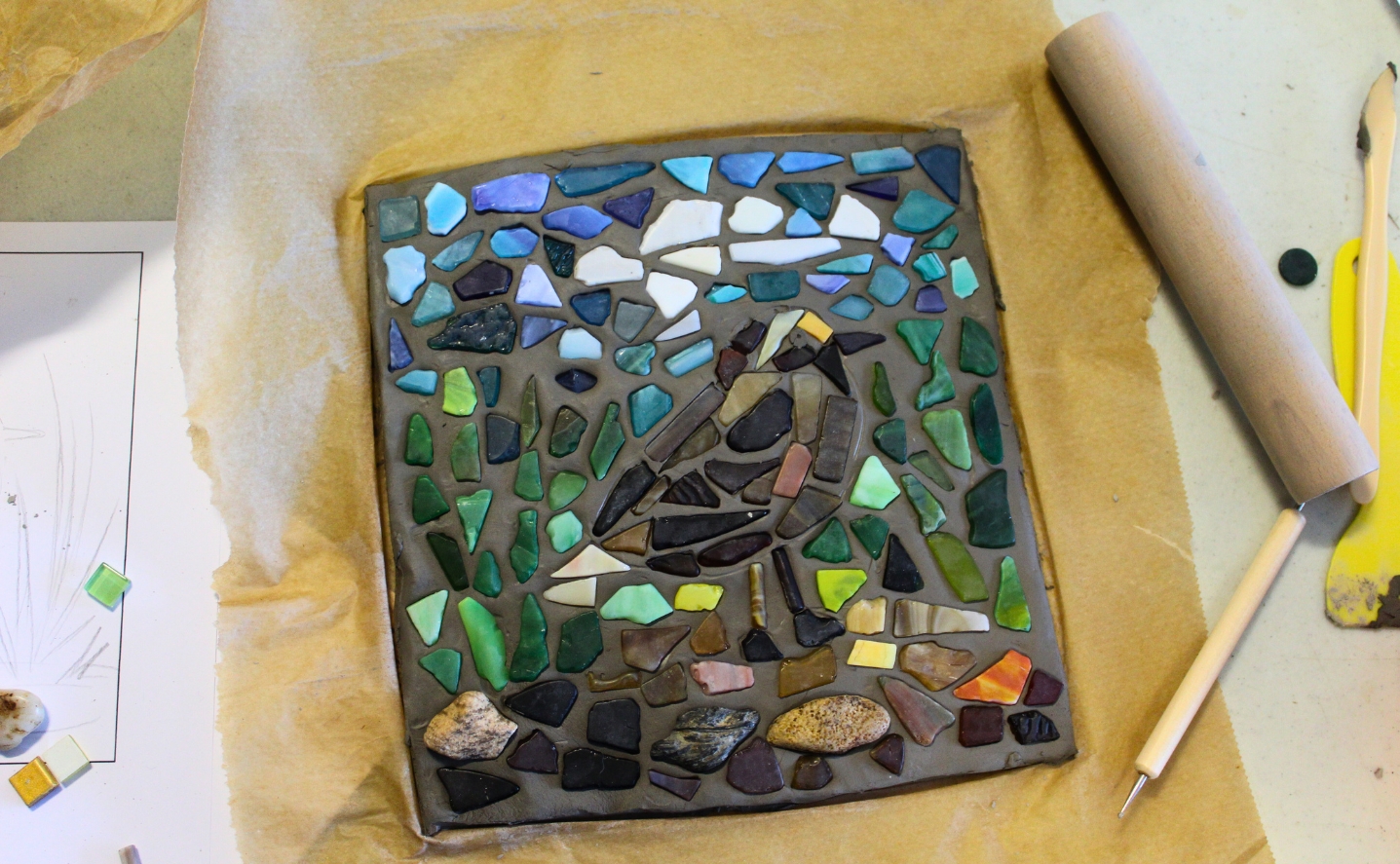 A colourful mosaic tile depicting a bird