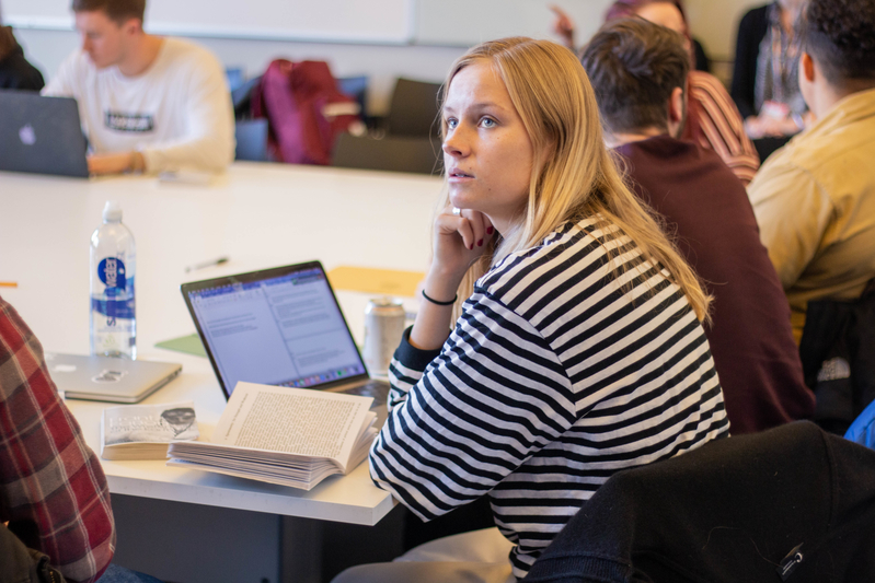 Students sitting together at a table, writing