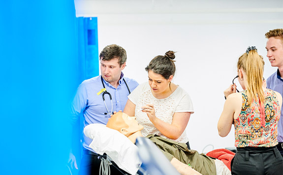 Medical students practising on a Manikin