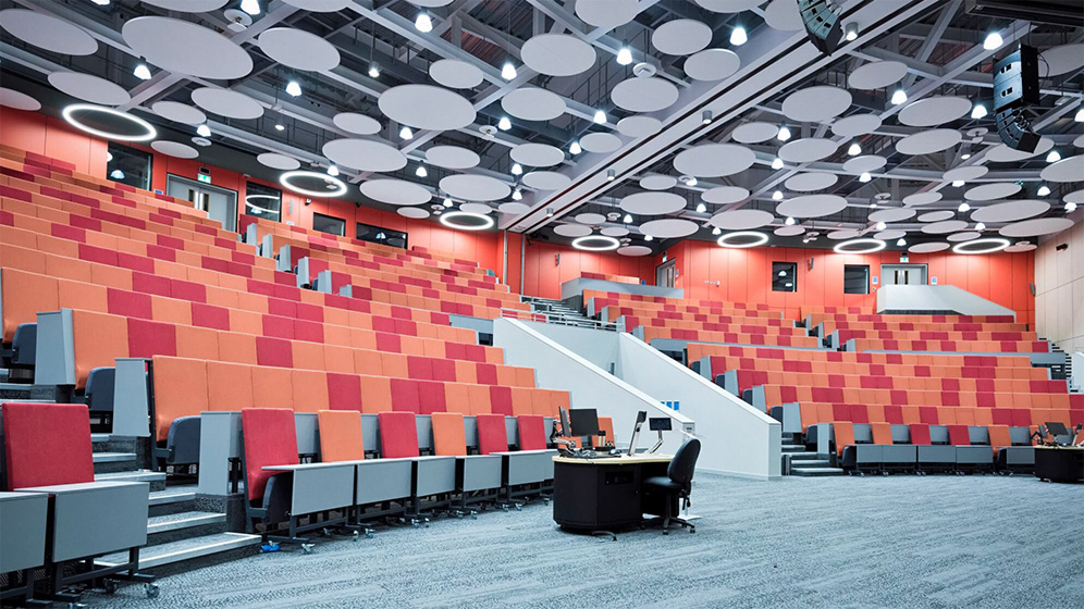 The inside of the conference area with red seating
