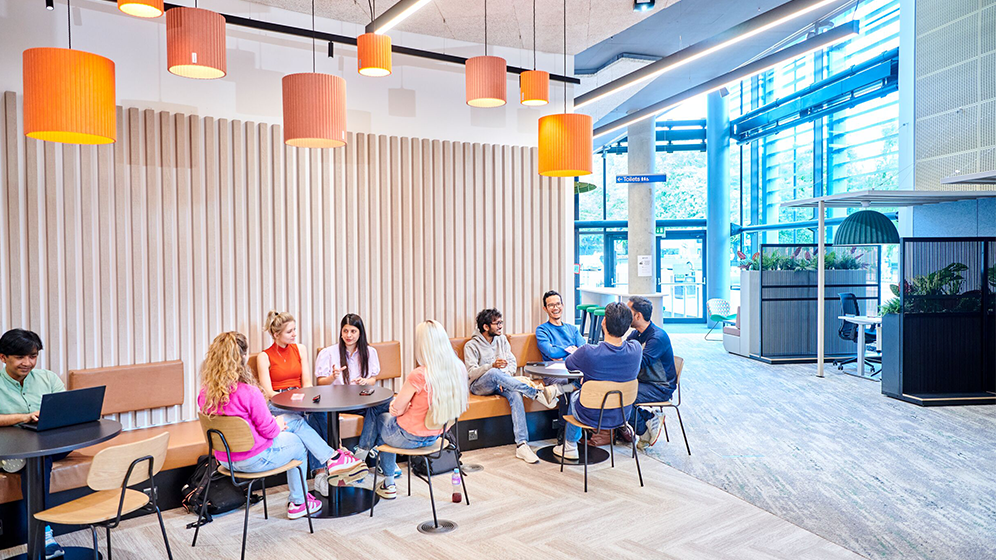 Students chatting at tables in the newly refurbished King's Gate