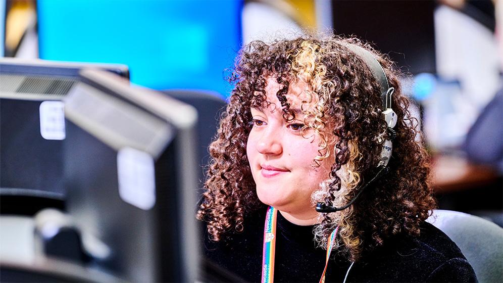 Student with headphones working at a computer