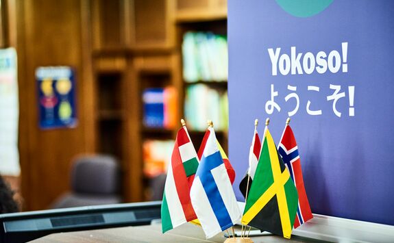 World flags with sign in the background saying Yokoso!