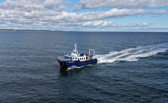 Small blue and white boat on the open sea