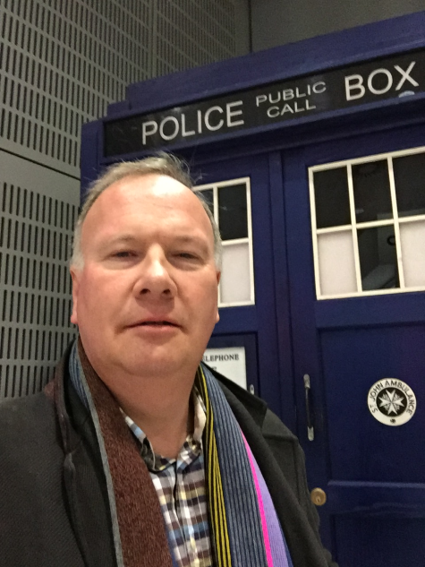 PhD student standing in front of a blue police box (like Dr Who)