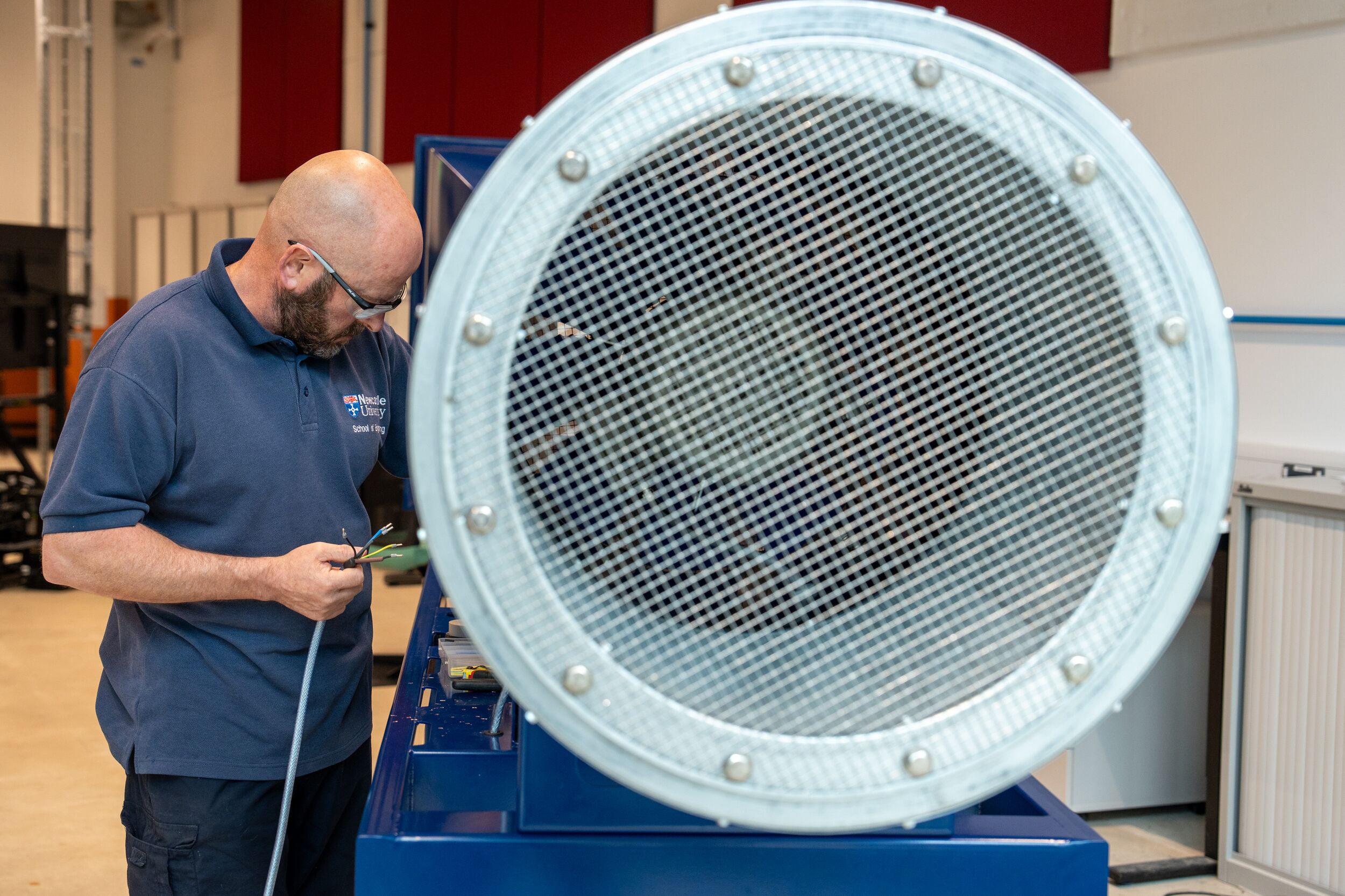A student stood next to large aerospace equipment