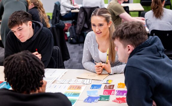 A group of students sat at a table, taking part in a group activity.