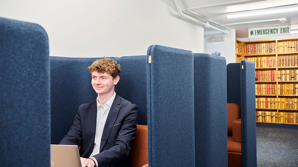 A student working in a pod in the Law School.