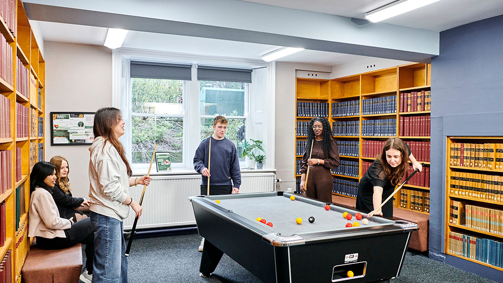 Students playing pool in the Law Common Room
