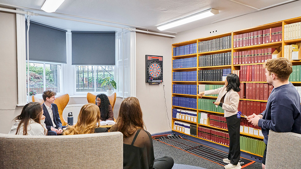 Students playing darts in the Law Common Room