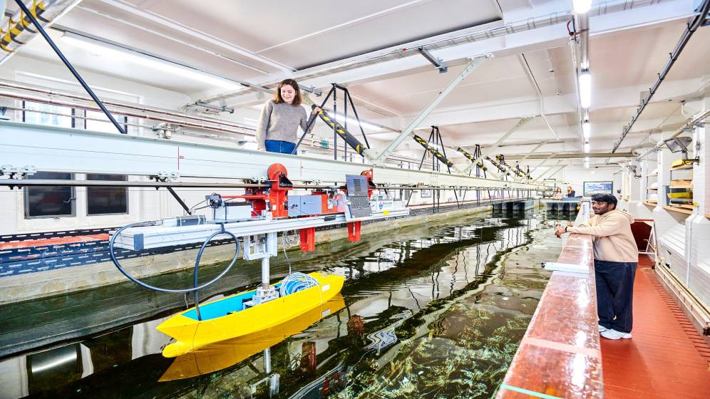 Two students observing an experiment in the Hydrodynamics lab.