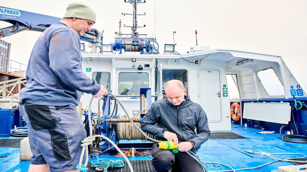 Two staff members fixing some rope on the research vessel Princess Royal.